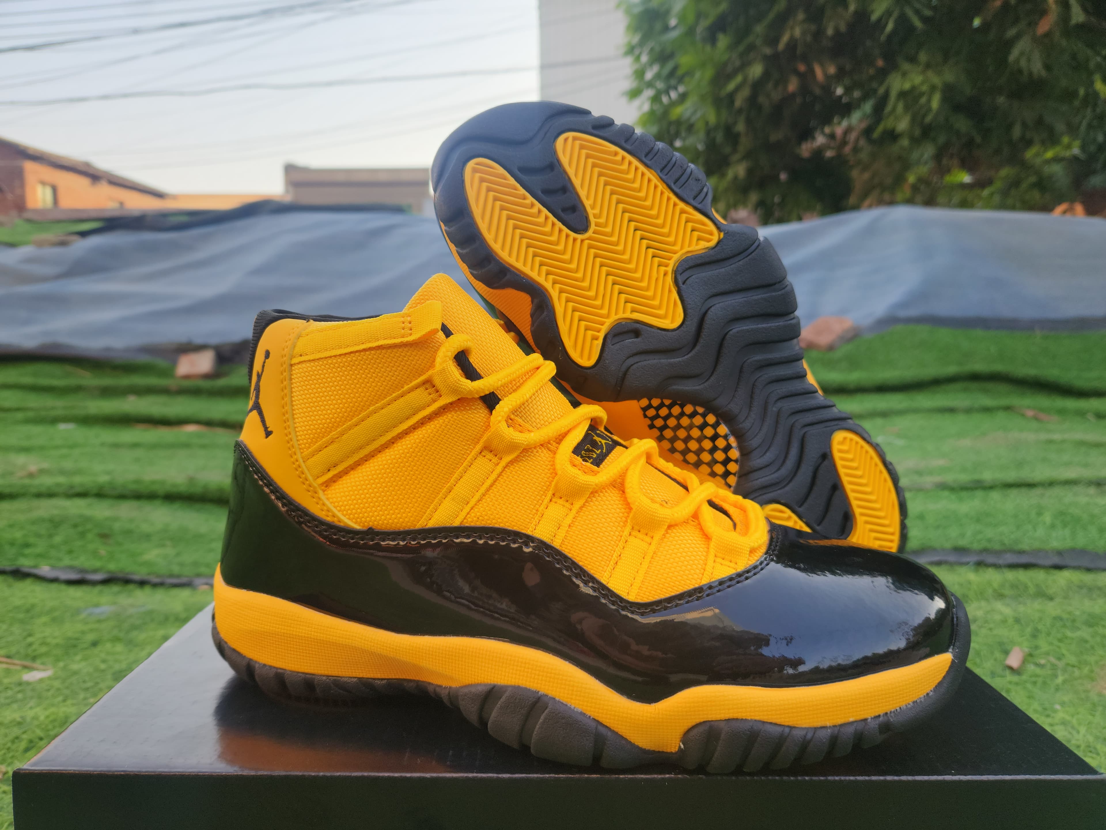AIR JORDAN 11 Jordan 11 in orange, yellow, and black.
