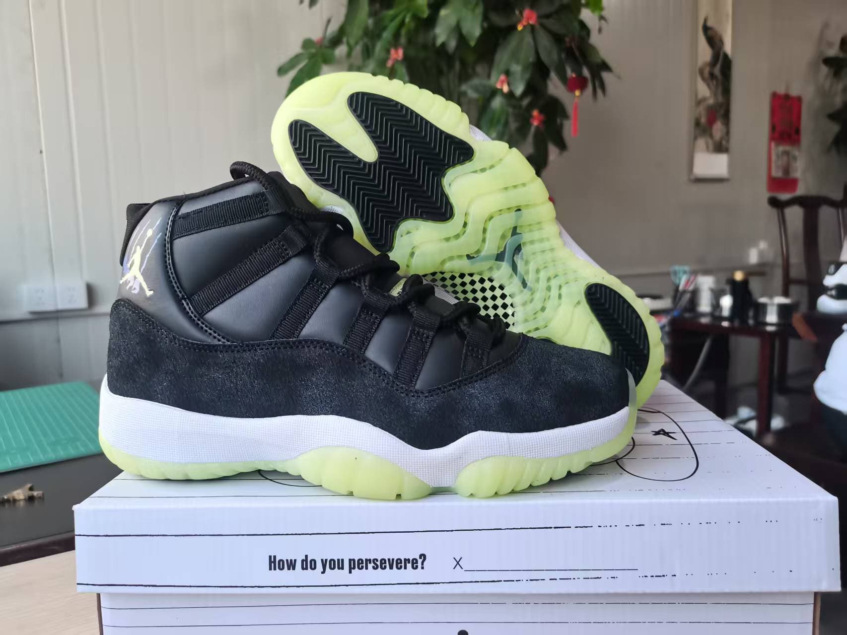 Air Jordan 11 in popular black with fluorescent green accents.